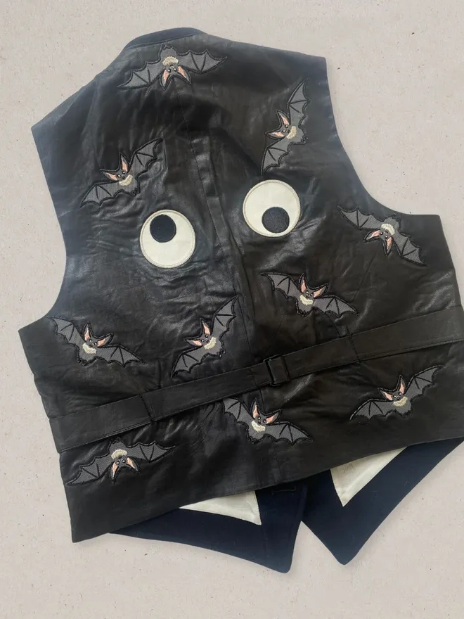 Bat embroidered iron on patches and big googly eyes on a waitscoat jacket.
