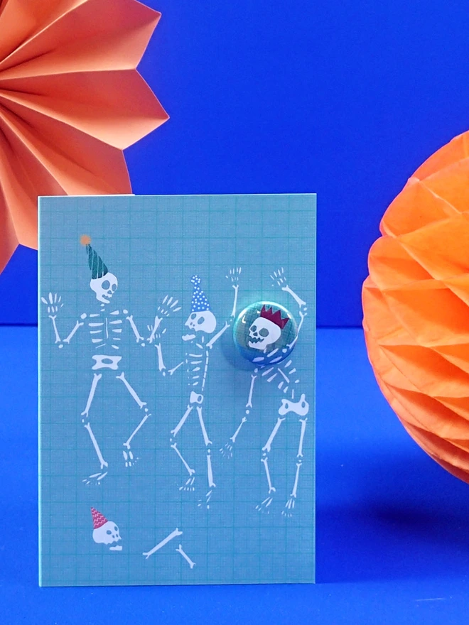 skull pin badge on a skeleton party birthday card