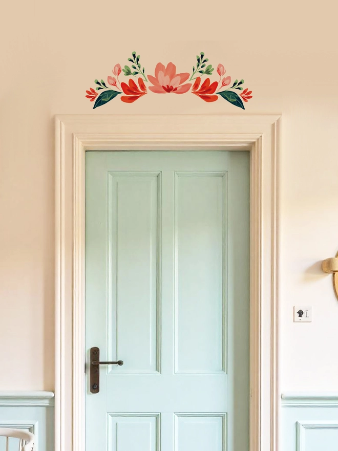 Internal door with an elegant floral wall sticker  / decal positioned above the door in different shades of red, handpainted floral wall sticker 