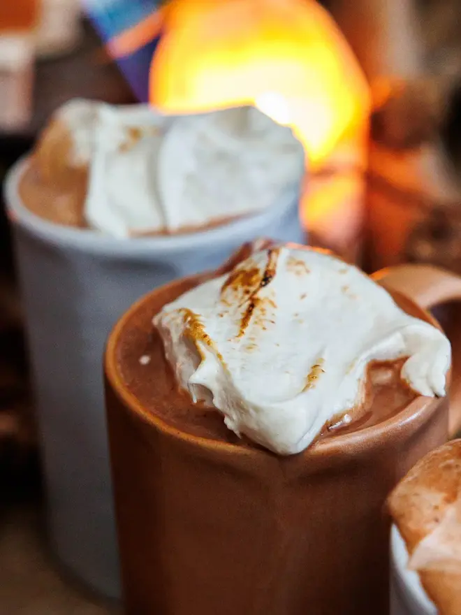 Vanilla Wonder Fluff Tub, two hot chocolates with marshmallows in them. Both have been fluffed. 