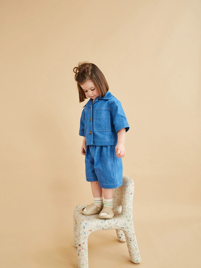 kid wearing cool organic denim coord look by studio koter with oversized korean style baby fashion