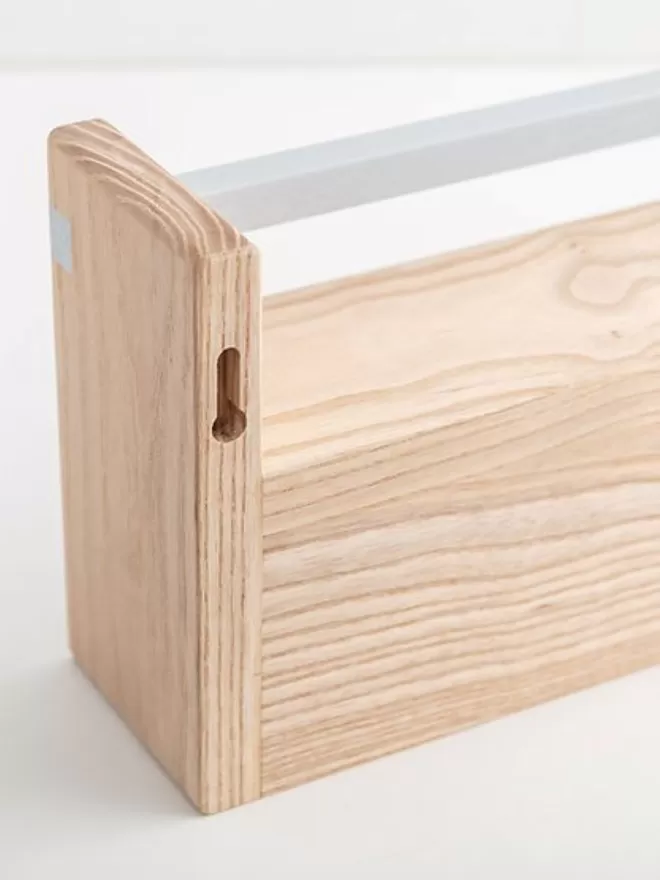Close up details of a beautiful solid wood handmade pegrail bookshelf 