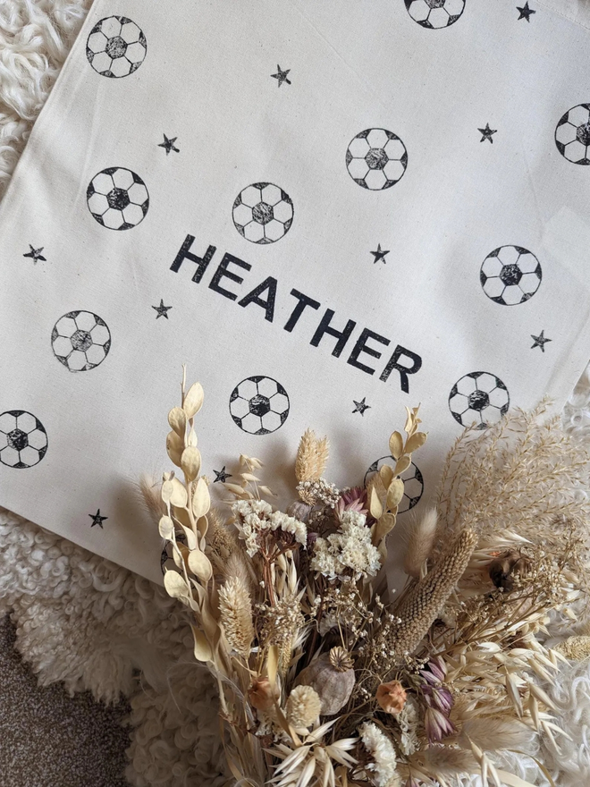 personalised football bag. a drawstring bag with printed footballs and a personalised name.