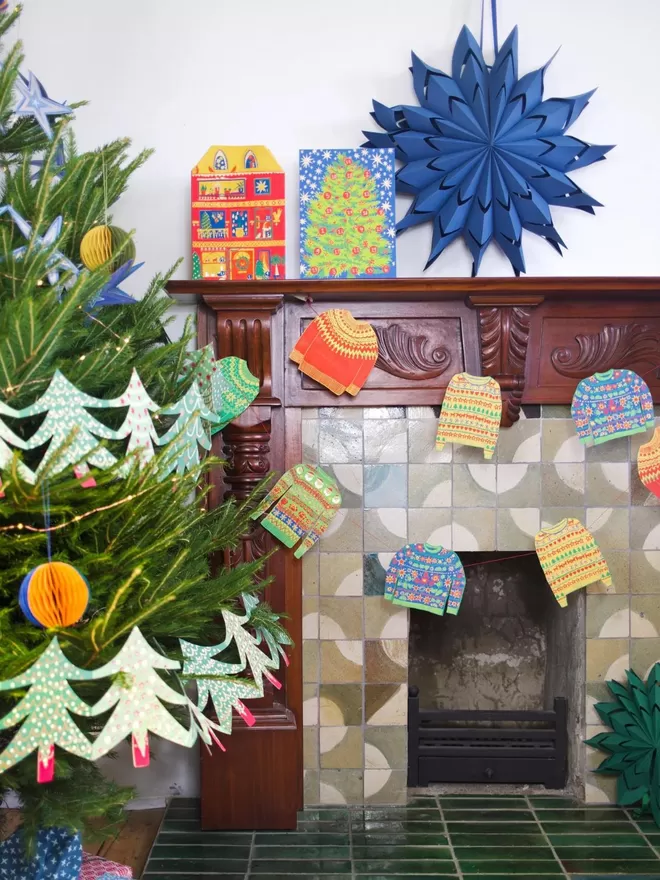 Christmas Jumpers Garland hanging across a fireplace