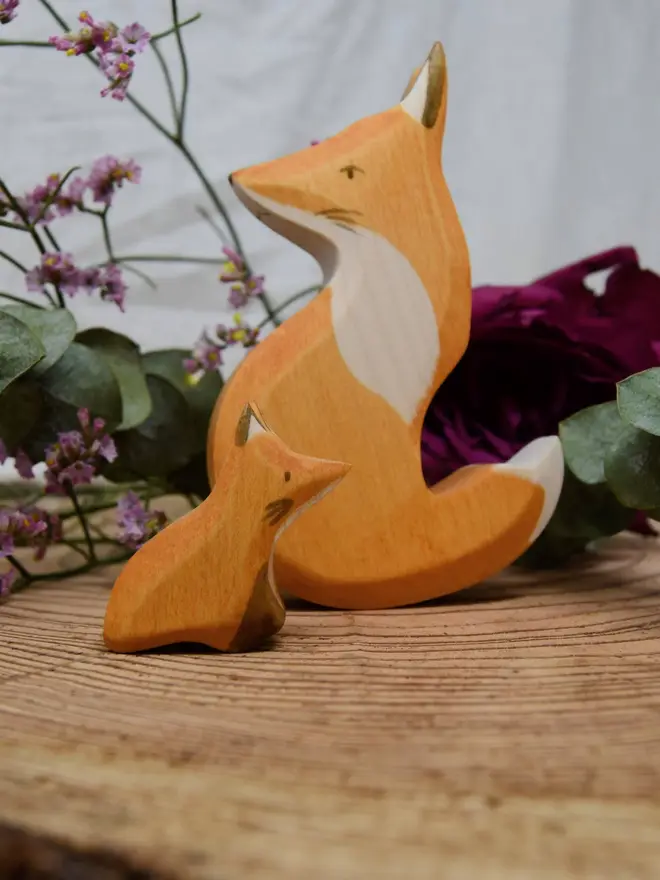 wooden fox toy that slot together to make a snuggling fox pair. made by eric and albert