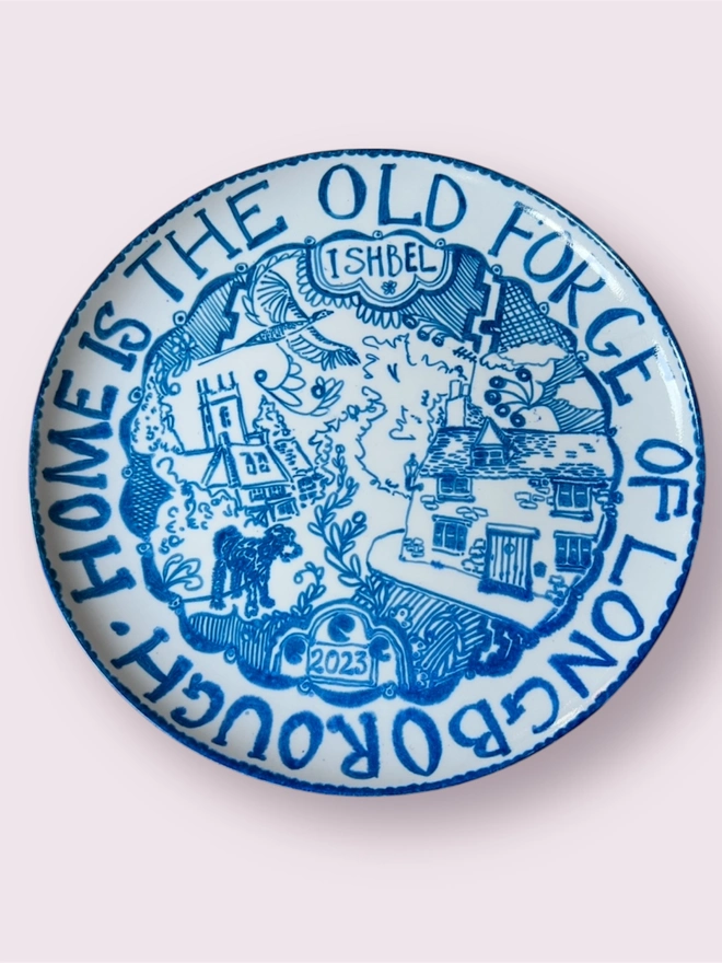 Detailed image of a country house on a blue and white plate