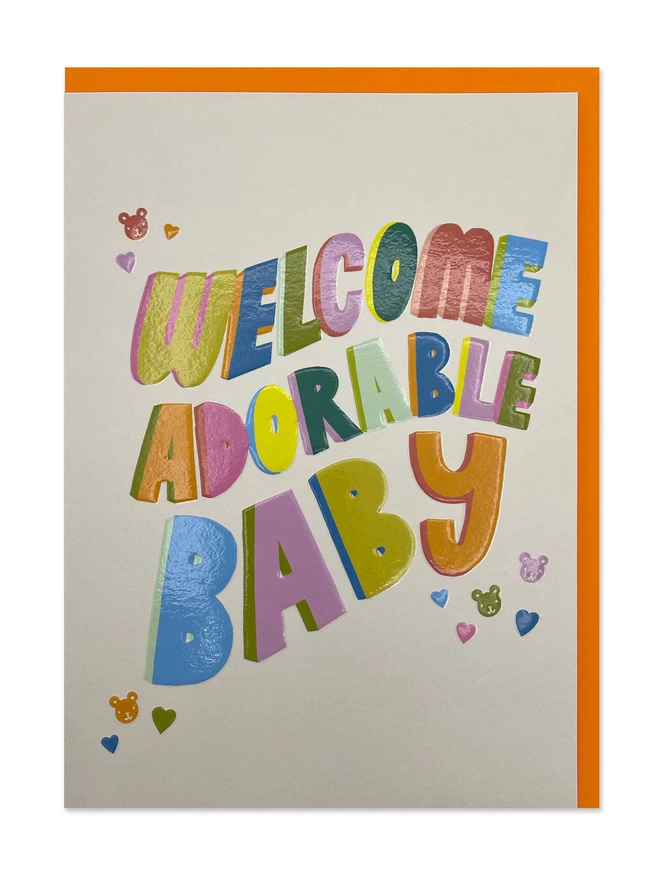 A colourful new baby card with bold rainbow type and a heartfelt ‘Welcome adorable baby’ message on a cream background