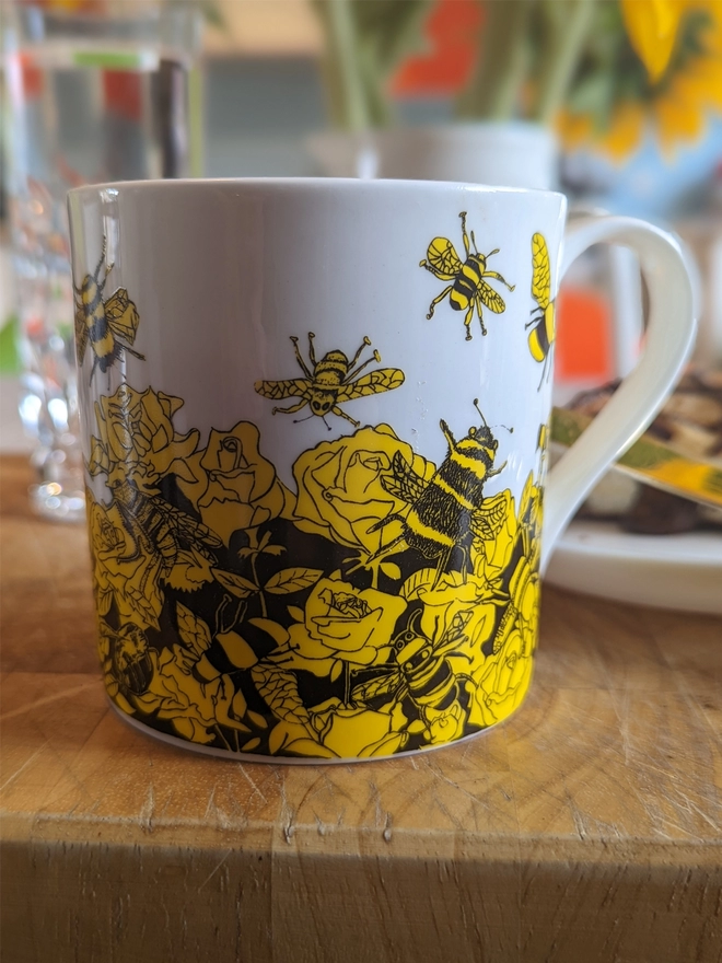 close up of bee free charity fine bone china bee gift  mug featuring yellow & black bee drawings