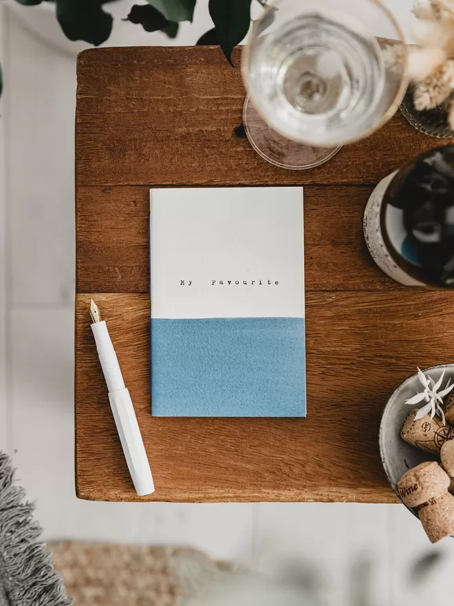 blue and white handmade notebook with the words 'my favourite' typed on the cover