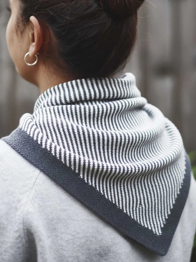 Lambswool Triangle Neck Scarf, a woman wearing a colourful neck scarf outdoors. 