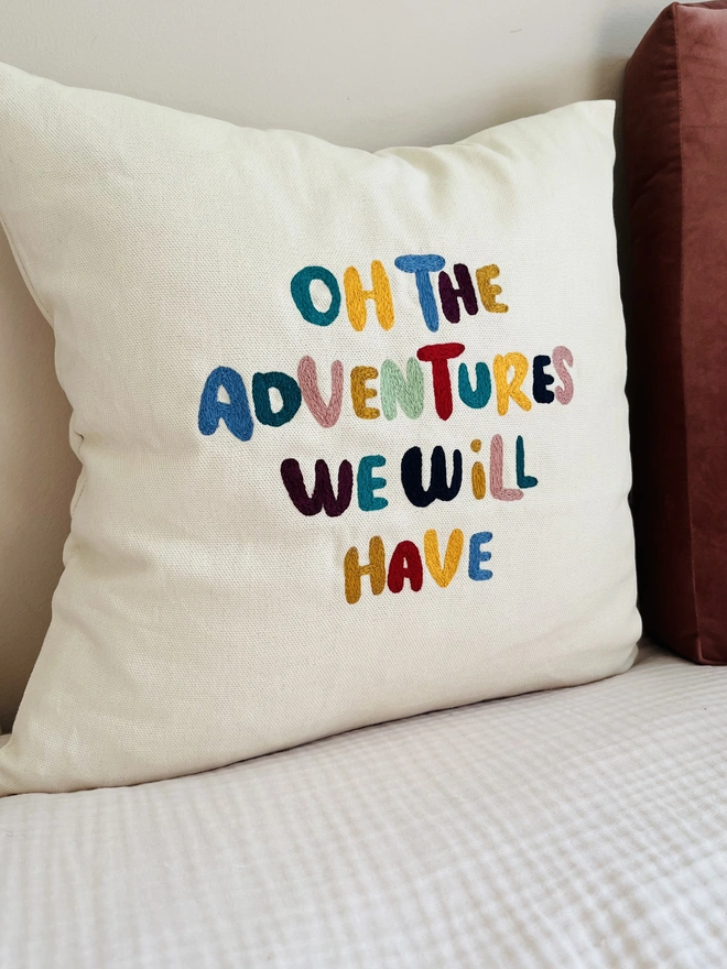 custom cotton cushion cover. embroidered cotton cushion on beige sofa.