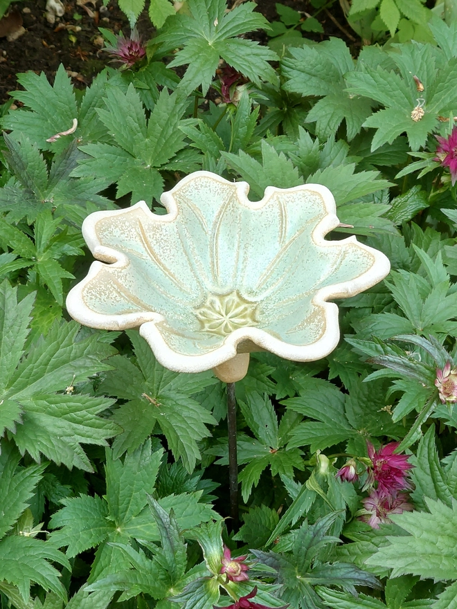 Seven petal ceramic flower bird bath on brass rod