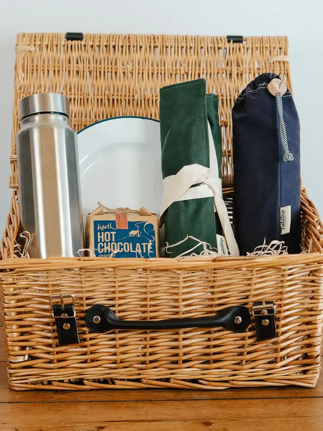 willow complete picnic hamper. a willow wood picnic basket filled with picnic cutlery, plates and cups.