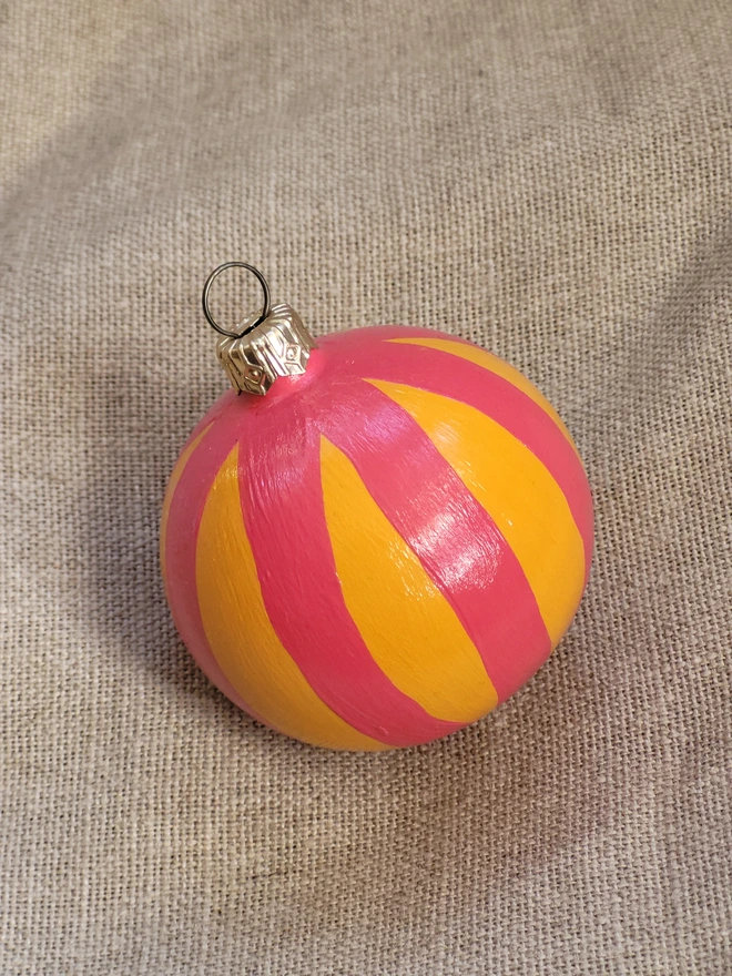Marigold yellow bauble with bright pink stripes