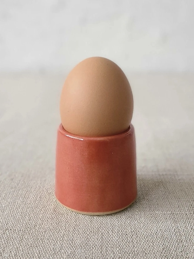 Classic Handmade Egg Cup, a ceramic egg cup sitting on a carpet surface against a grey backdrop. 