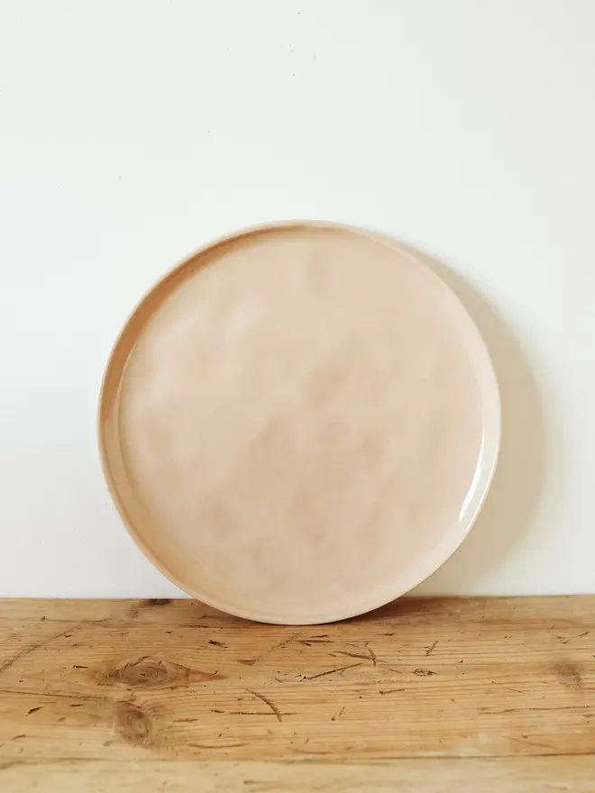 stoneware place setting dining set. a large pink stoneware plate.