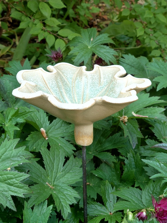 Seven petal ceramic flower bird bath on brass rod
