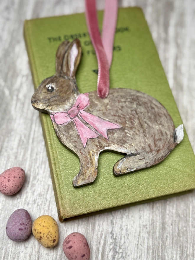 Easter Bunny Decoration with the name Olive on a hand  - painted ribbon round its neck   and a pink velvet ribbon to hang