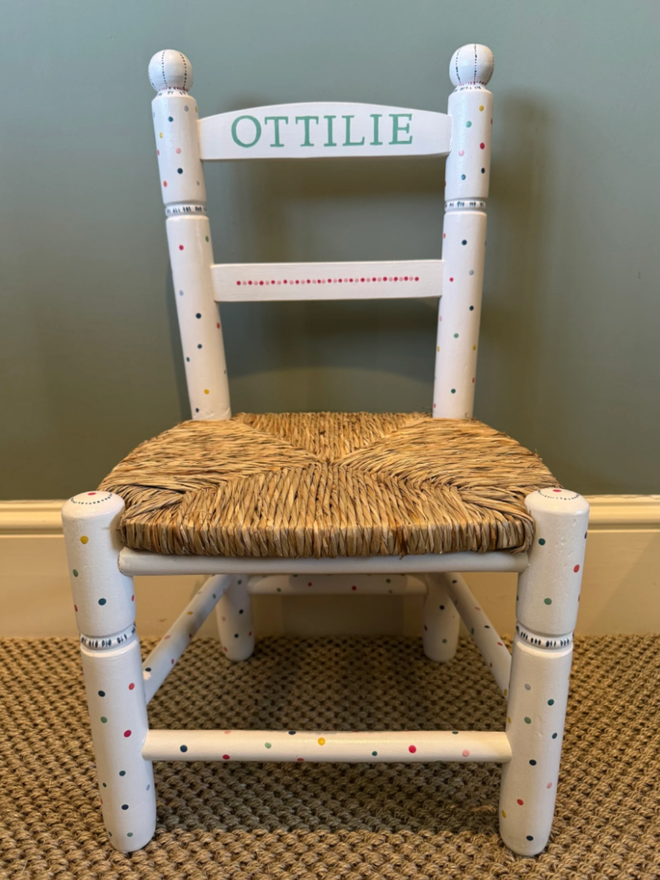 Ottilie Hand Painted Chair. A white chair with multicoloured dots.