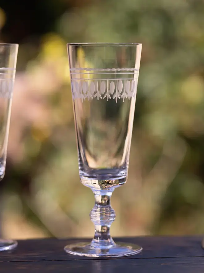 engraved ovals champagne flutes (set of 4). a champagne glass with an oval pattern around the rim.