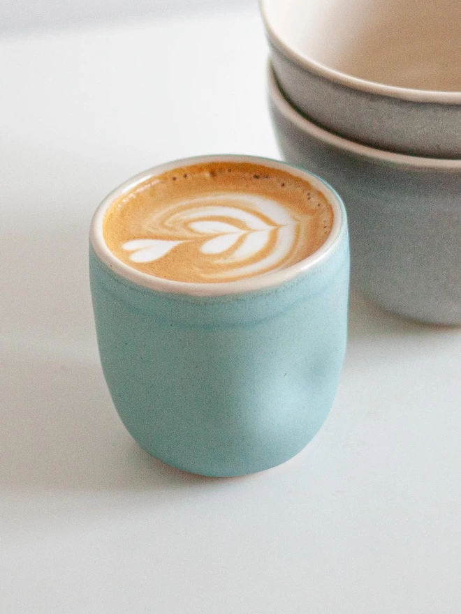 Image of the blue dimple cup with coffee in it.