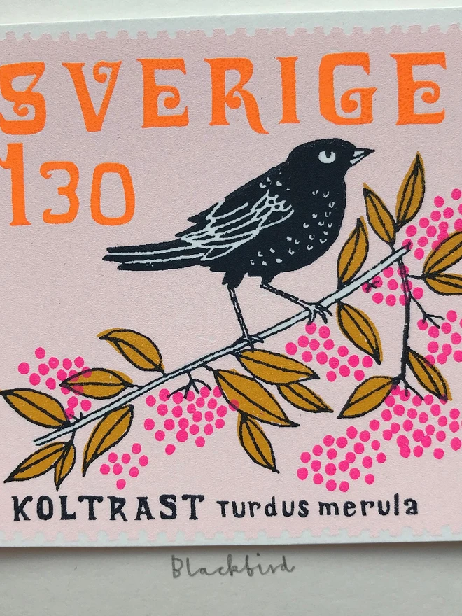 Bird Stamp Card Swedish/ Blackbird, a white card with a colourful bird design on a white backdrop. 