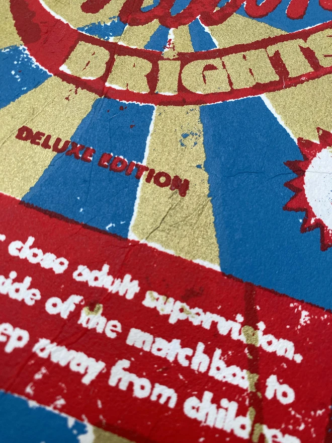 Bring a touch of nostalgic British charm to your space with this striking London Brights limited edition screen-print, inspired by the bold graphics of fireworks labels.     Featuring a vibrant palette of red, blue, and gold, the design showcases dramatic sunburst rays and retro typography, capturing the energy and character of classic mid-century advertising.      Each print includes the artist’s signature and edition number, this piece is perfect for lovers of London, vintage design, and unique statement art.