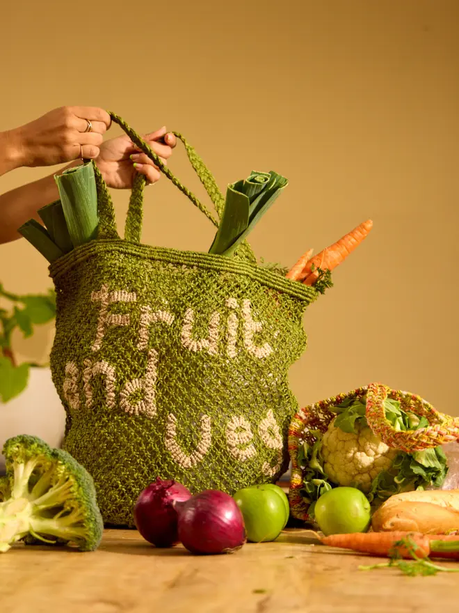 'Fruit and Veg' Jute Tote Bag filled with fruit and being held