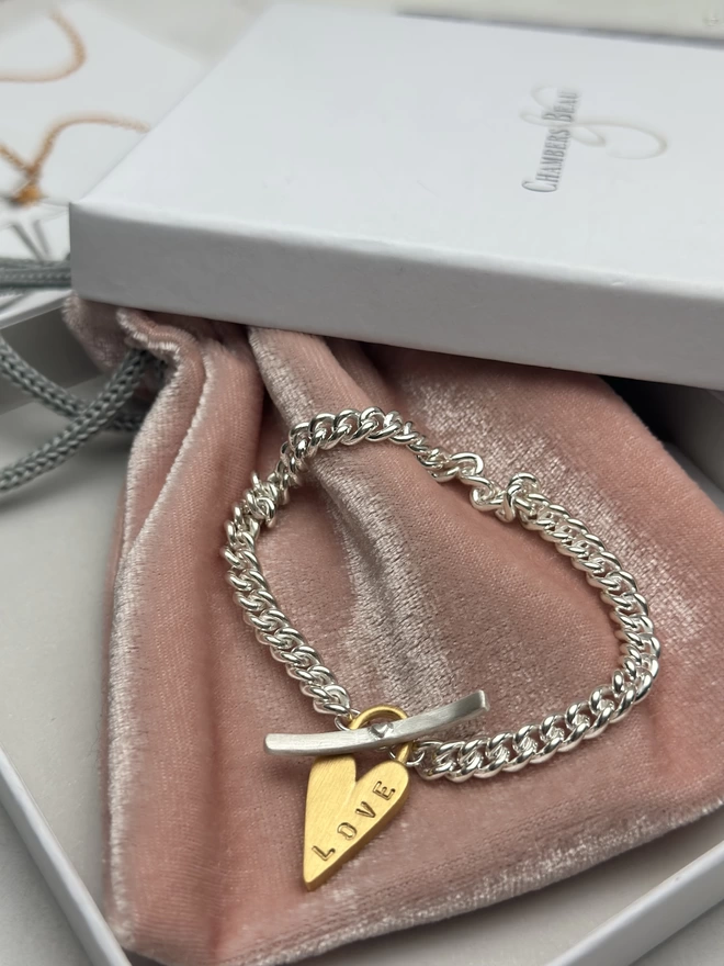 sterling silver chunky curb bracelet with silver t bar fastener and personalised gold chunky heart padlock charm. with gift box and pouch