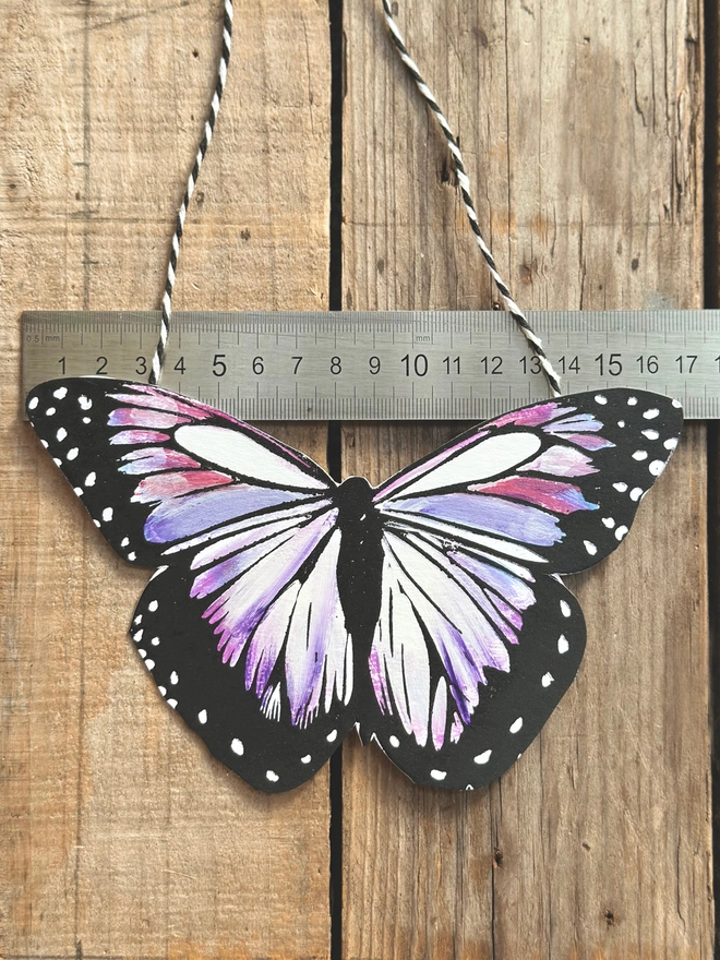 Hand Painted Butterfly Colourful Linocut Hanging Decoration In purple lilac and black with a ruler to show the size of the wings which are 17cm wide