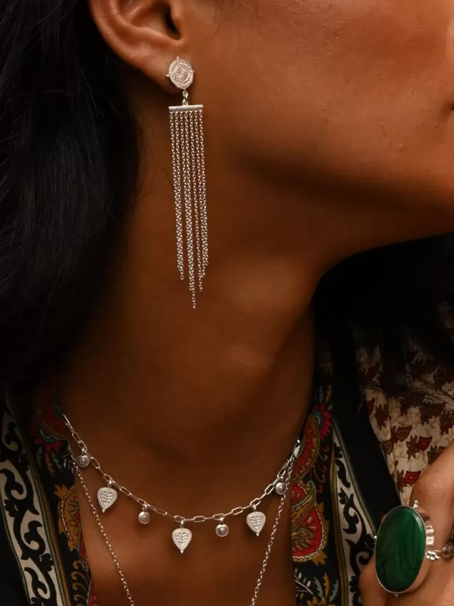 Silver fringe earrings on model