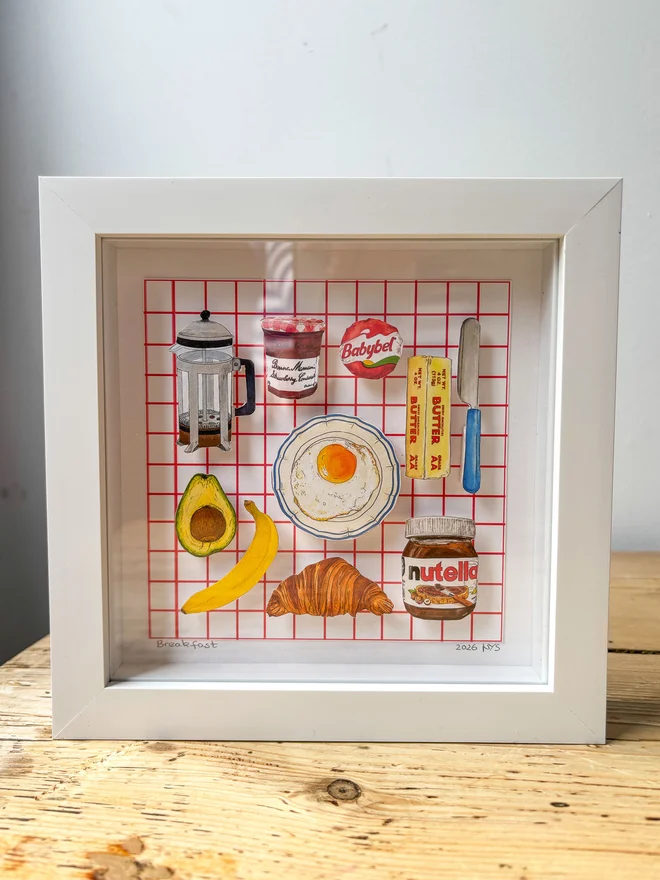 Framed Illustrated 3D paper collage showing favourite breakfast staples standing on a wooden surface