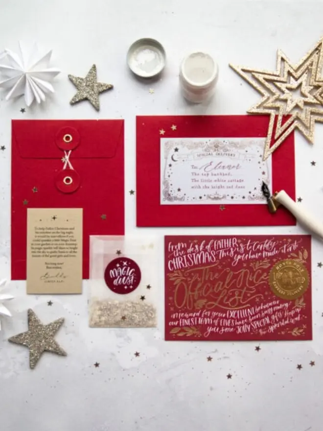 A red foil certificate laid out with red envelopes, a Magic Dust packet and a Chief Elf note.