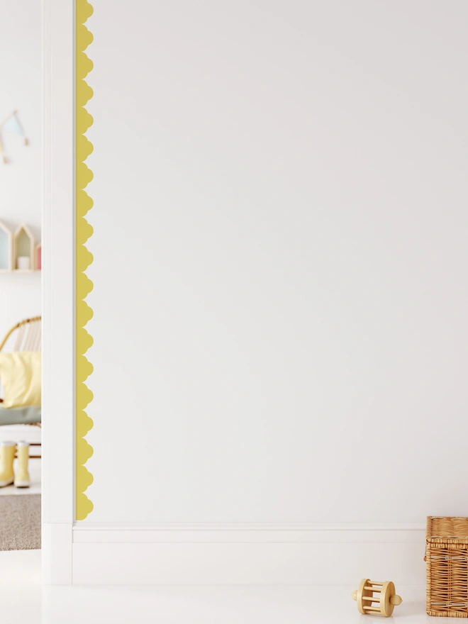 Temple scallop in yellow framing a doorway on a white wall