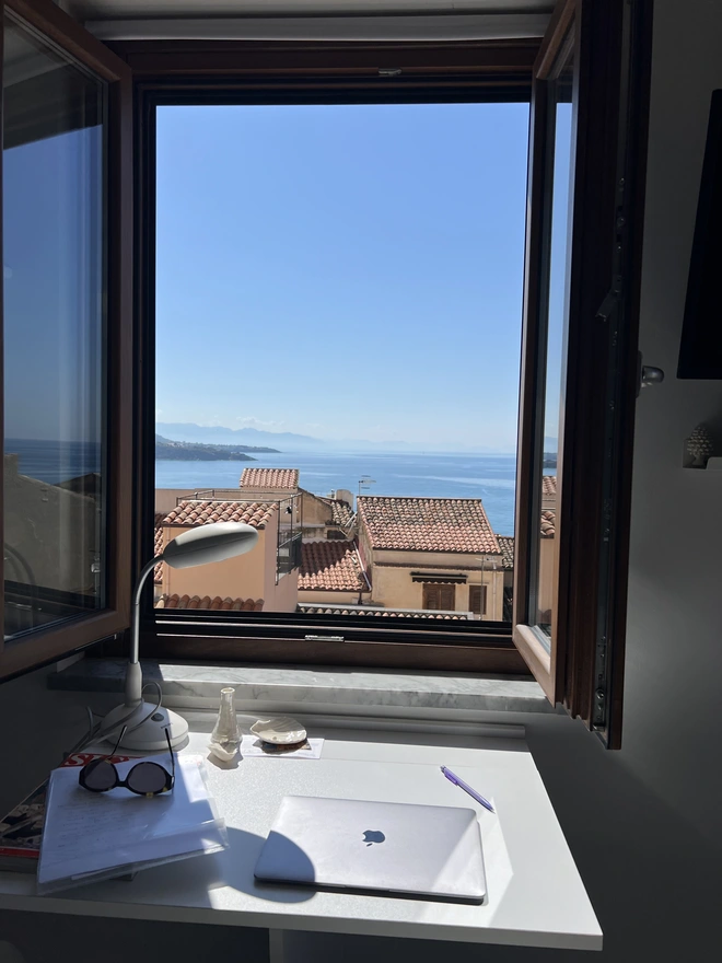 handmade pearl lustre porcelain bud vase on sunny windowsill in Cefalu sicily