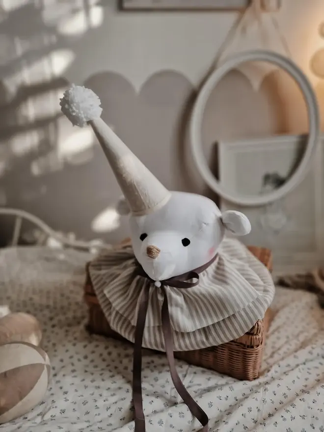 Bear Head Nursery Decoration, a bear decoration sitting against a wall in a child's decorated bedroom. 