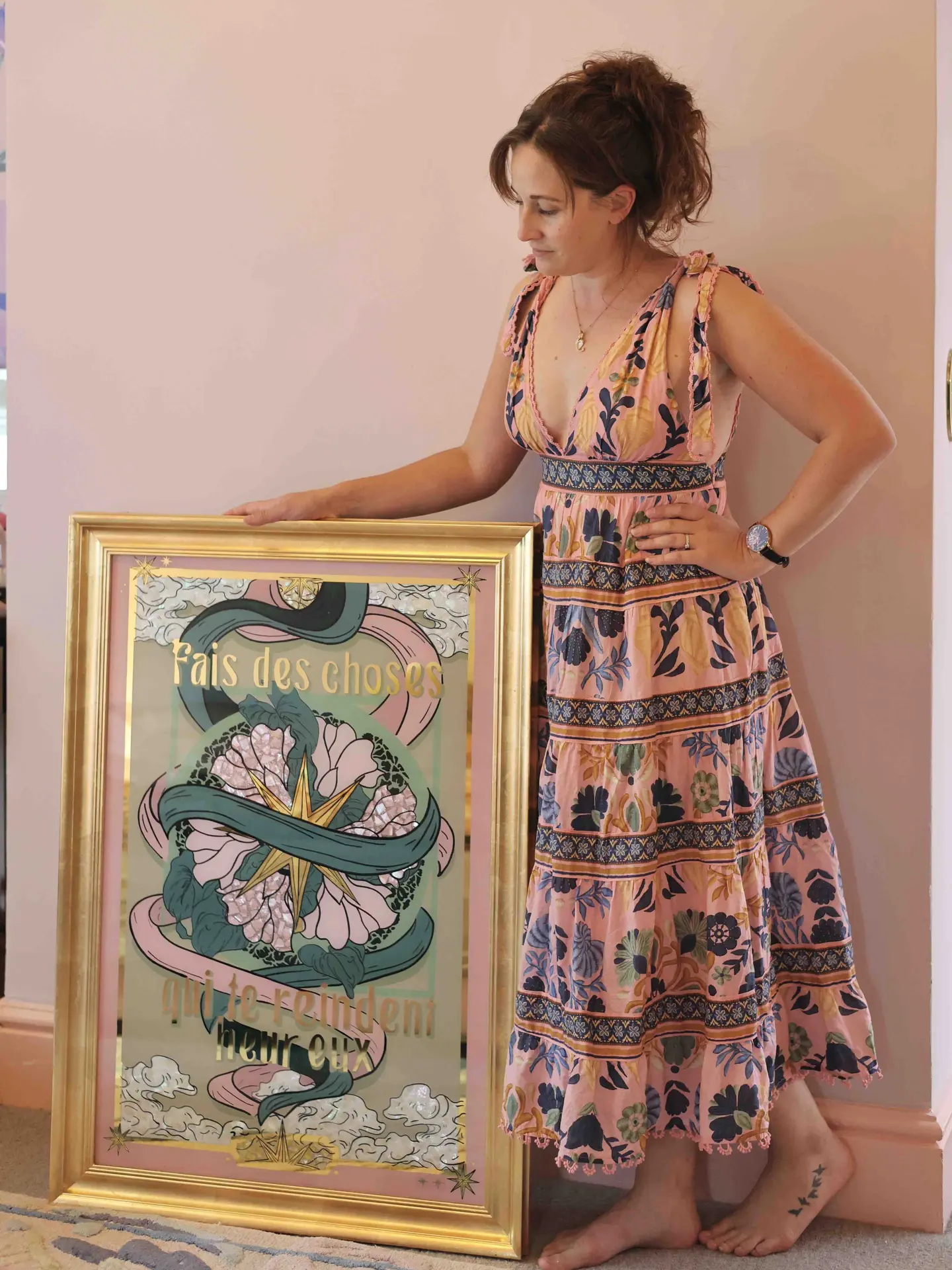 Original Glass Artwork “Do Things That Make You Happy”, being held by a woman. 