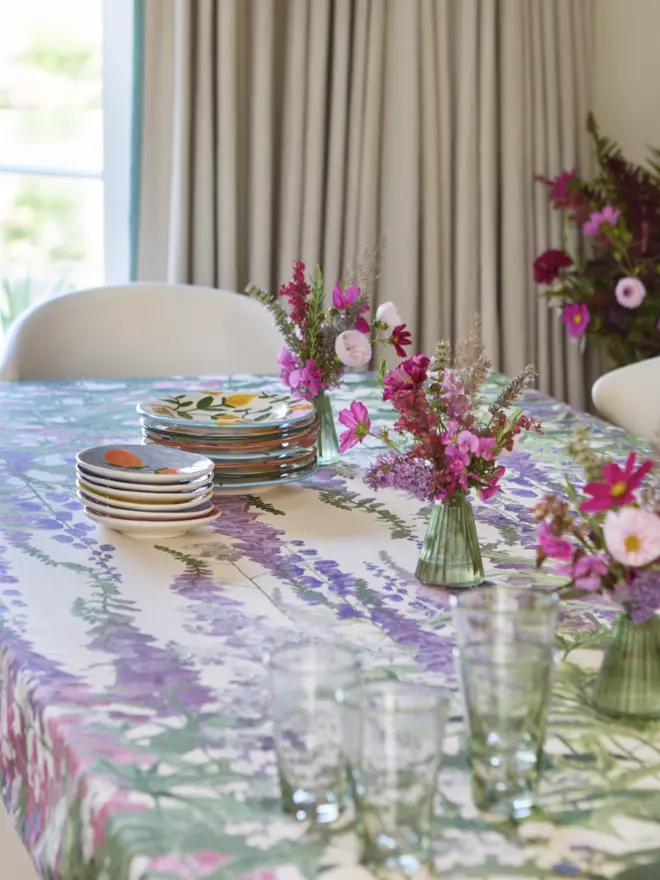 Summer garden tablecloth covered in English wild flowers in pinks and purples