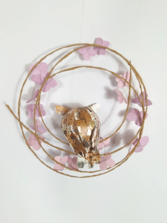 back view of woodland wall art featuring a long eared owl baby on a spring wreath