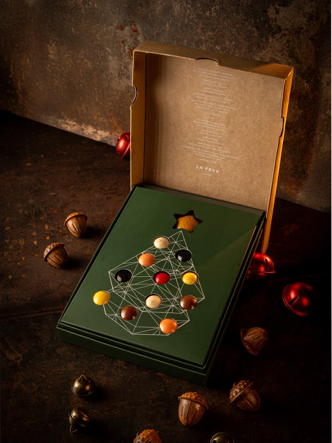 Christmas tree chocolate open, showing eco-lux green paper packaging