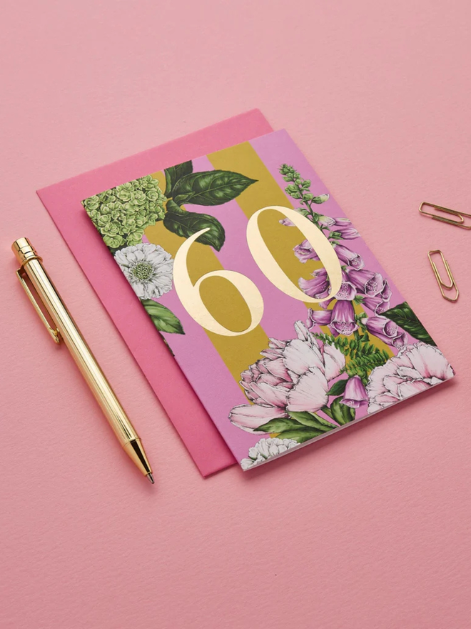 floral age milestone card. a pink floral 60th birthday card photographed against a pink background.