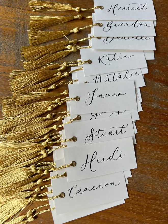 Personalised Calligraphy Wedding White Place Cards, white place cards with ivory and gold tassel. 