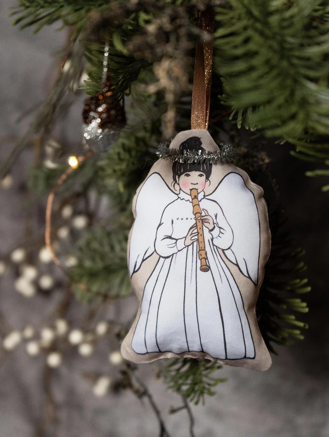 christmas tree angel playing a recorder made from fabric with a tinsel halo