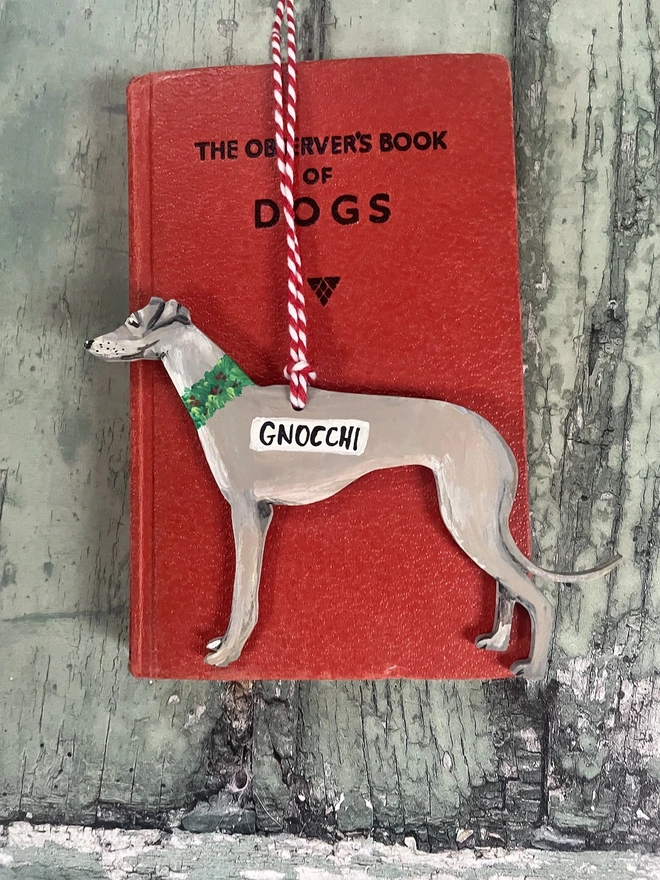 Grey whippet handpainted Christmas tree decoration hung with red and white twine