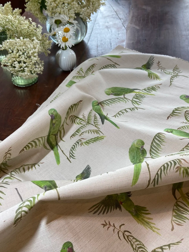 Parakeet tablecloth. A tablecloth patterned with light green parakeets.