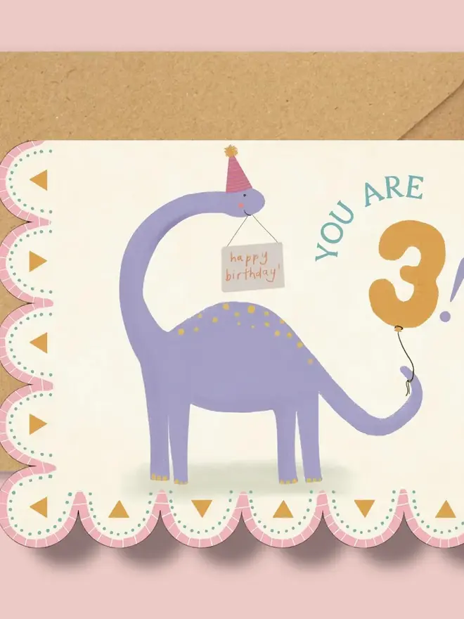 illustrated dinosaur birthday card. scallop edged card illustrated with stegosaurus.