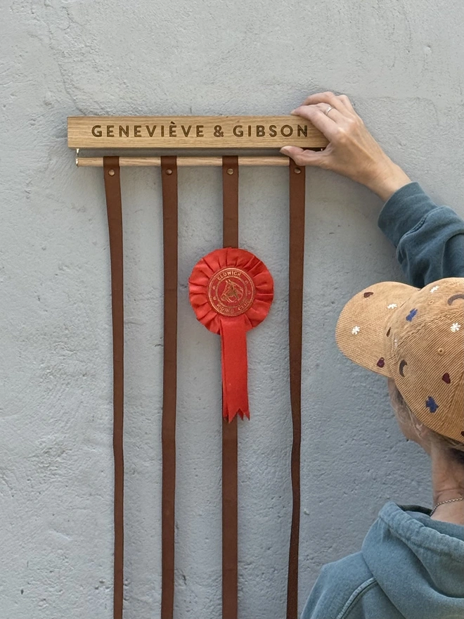 oak wooden rosette display holder against a stone wall 