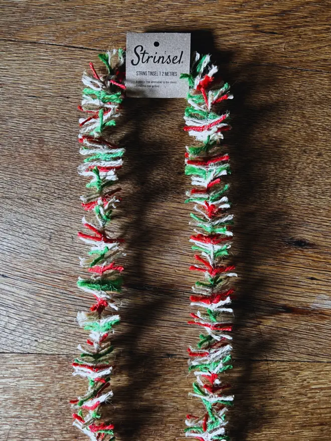 Red, white and green Candy Cane jute string tinsel AKA Strinsel with label on an oak table