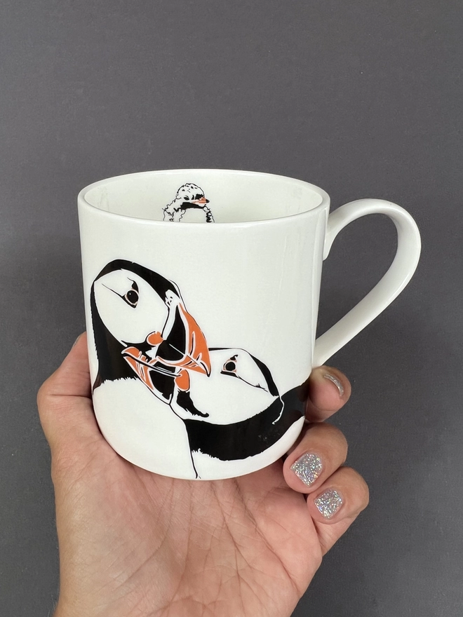 Image of the front and inside of the 'Puffin nuzzle' mug 