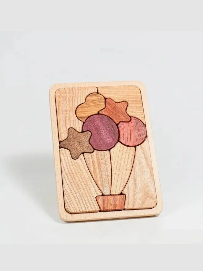 Sky Bloom Wooden Persistence Jigsaw Puzzle Heirloom Toy, against a grey background. 